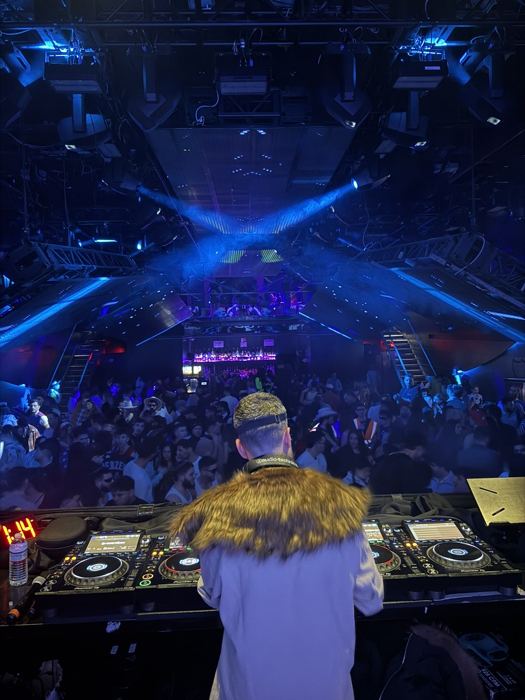 Club crowd from behind the decks